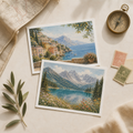 Two illustrated travel postcards beside a vintage compass and map